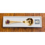 A Georg Jensen silver gilt presentation spoon, enamelled purple pansy to the handle,