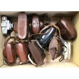 A box containing a collection of assorted 35 mm cameras, mostly mid 20th Century including Kodak,