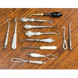 Twelve various miniature button hooks to include silver handled, agate set handle,