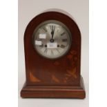 An Edwardian mahogany eight day mantle clock, with a silvered dial,