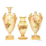 Three Royal Worcester blush ivory vases including a pair of mask moulded twin handled pedestal