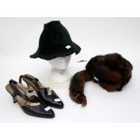 A dark green velvet 1940s hat with braiding around the brim and a pair of black leather,