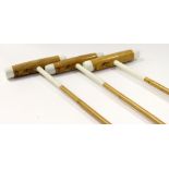 A collection of three Asprey polo mallets.