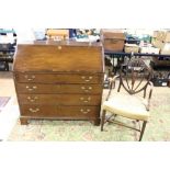 A George III mahogany bureau, with four graduated drawers with brass swan neck handles,