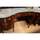 An Edwardian mahogany inlaid marble topped pedestal kneehole desk, fitted with a central drawer,