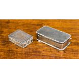 Two white metal snuff boxes, one with unidentified marks and engraved decoration on the exterior,