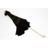 A silk early Victorian brown parasol, having carved ivory handle,