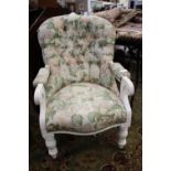 A Victorian upholstered armchair, having a white painted frame,