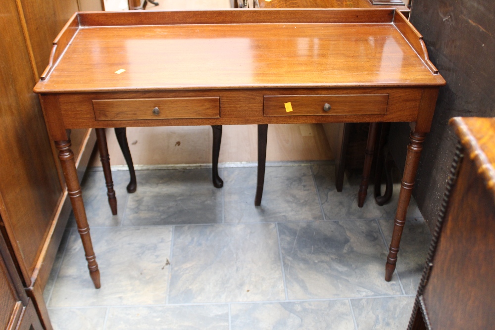 A 19th Century mahogany writing table, gallery back, having two short drawers,