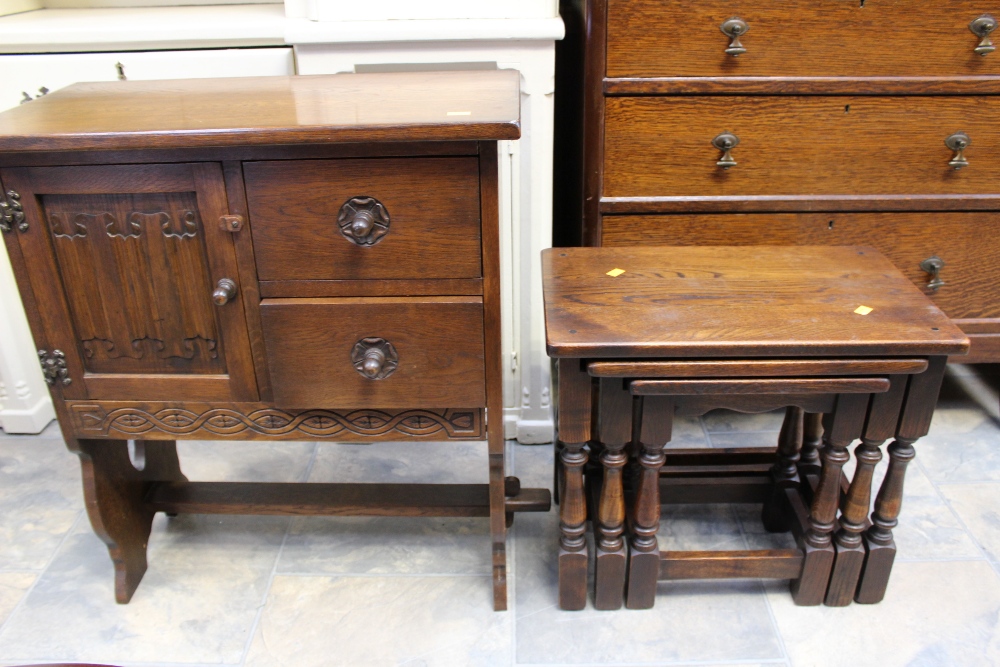 A small oak drop-leaf coffee table and a ladies oak sewing table,