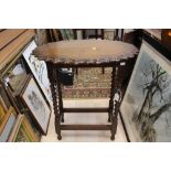 An early 20th Century oak side table, raised on barley twist legs,
