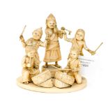 An Indian ivory carved group, depicting children playing instruments, circular base,