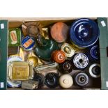 A box containing a collection of various tobacco jars, Bakelite lighters, various ashtrays,