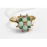 A diamond, emerald and opal 22ct yellow gold star cluster ring, ring size Q½,