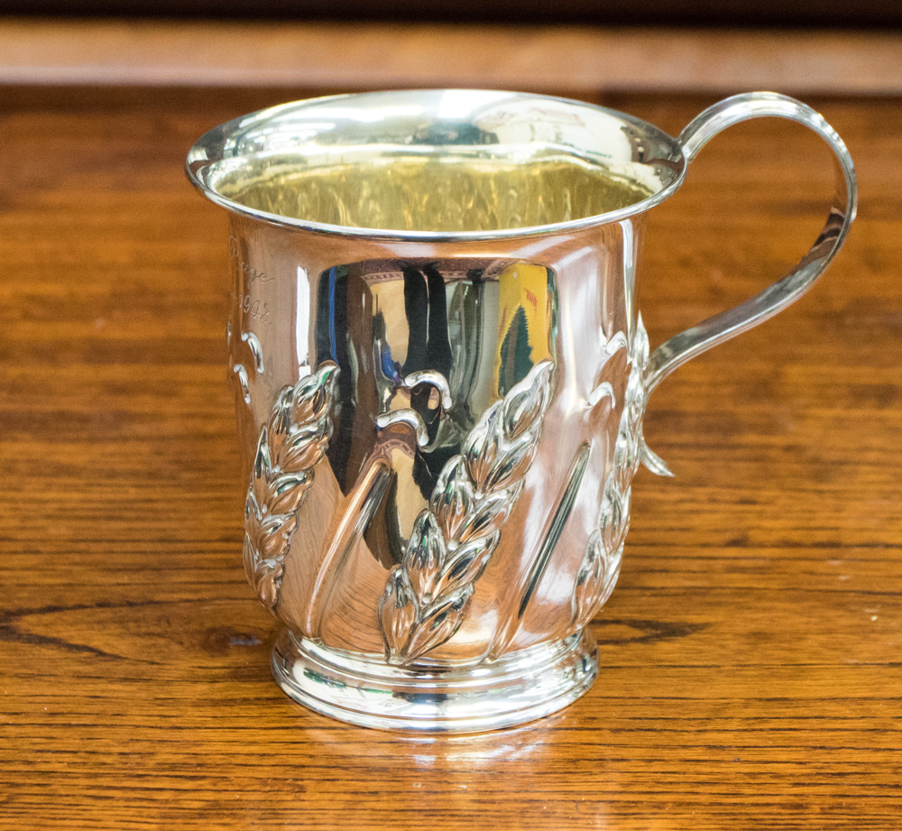 A late Victorian silver mug, embossed with wheat motifs, inscribed Harvey Pager, July 25th 1942,