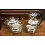 A George V silver matched four piece tea set, beaded border, ebonised handles, Viners Ltd,