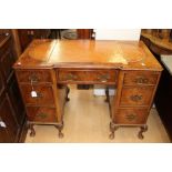 A George III style mahogany twin-pedestal desk, the top inset with leather,