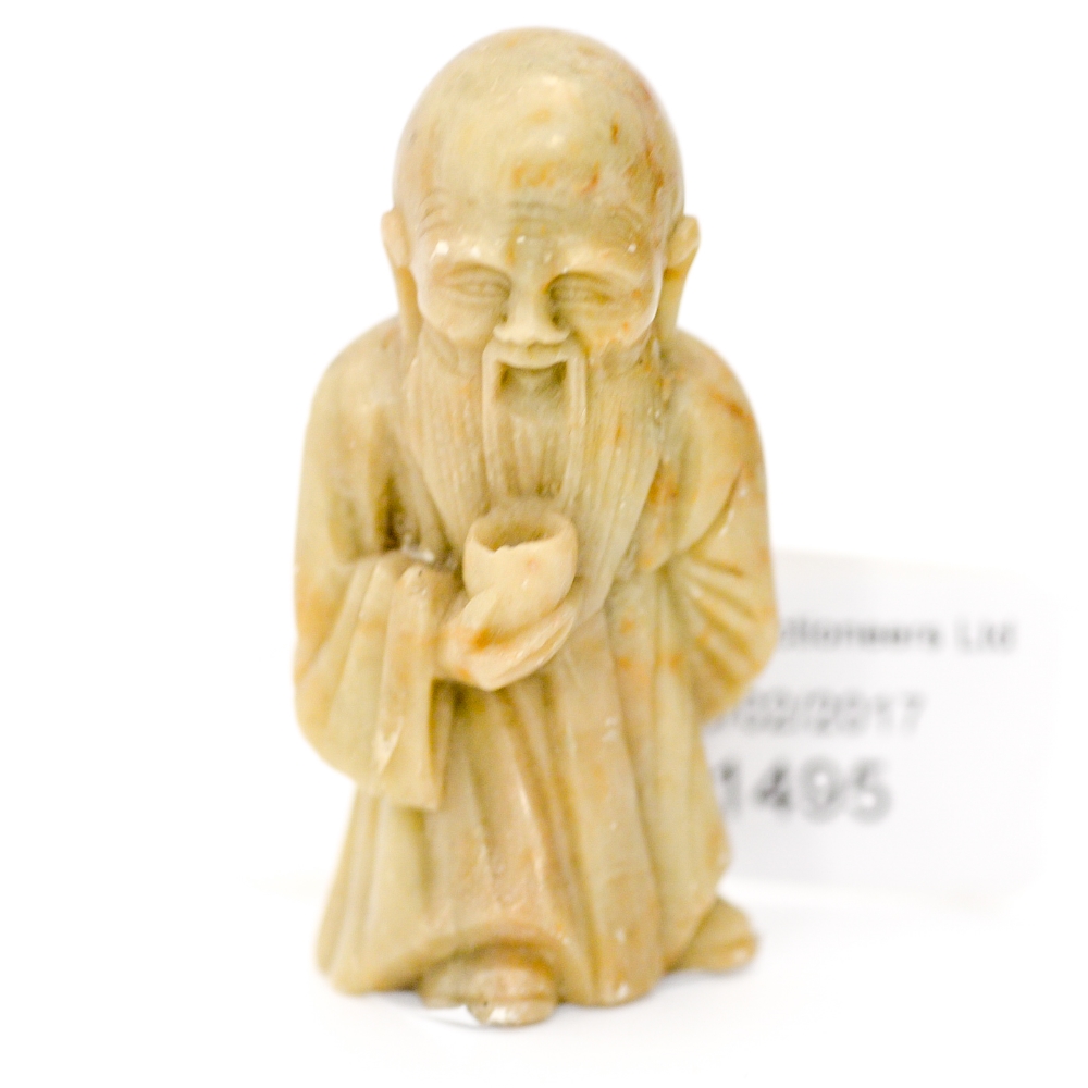 A Chinese carved hardstone figure of an elder with cup