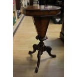 A Victorian octagonal walnut ladies work table, raised on cabriole legs, 76cm high,