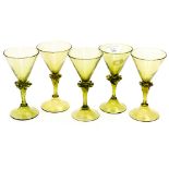 Five Continental Wrythern wine glasses with knops that have applied rippled glass decoration,