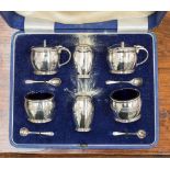 A cased, six piece silver condiment set, comprising, two salts, two peppers, two mustards,