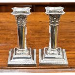 A pair of Edwardian silver dwarf candlesticks,
