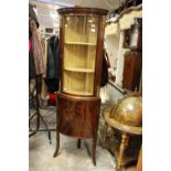 A Georgian style mahogany corner display cabinet, the upper section with a single glazed door,