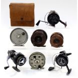 A collection of seven fishing related items to include: two wooden fishing reels with a Condex