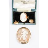 A 19th Century shell cameo brooch depicting a scantily clad classical maiden,