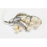 A 14ct white gold cultured pearl brooch, floral form, length approximately 55mm (clasp broken),