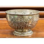 A silver rose bowl with embossed floral and foliate decoration, raised on pedestal foot,