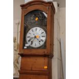 A 19th Century French pine cased longcase clock, the white porcelain dial with black Roman numerals,