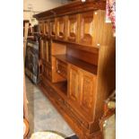 A traditional oak veneered side unit, constructed in two sections,