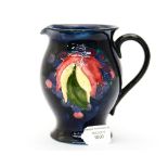 Moorcroft jug etched signature grape and leaf pattern on blue ground