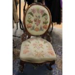 A Victorian walnut ladies chair, carved back, measuring 106cm high,