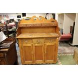 An early 20th Century teak and pitch pine dresser, the upper section with five spice drawers,