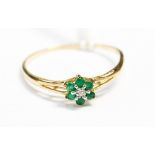 A yellow metal diamond and emerald ladies dress ring, size T½,