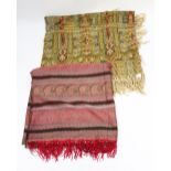 A woven paisley silk shawl in pinks, reds, greens with woven red fringe,