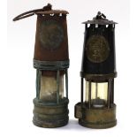 An Eccles miners lamp and an older version, both with tag No.