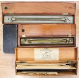 A collection of drawing instruments, comprising box of drawing aids, roller rule,