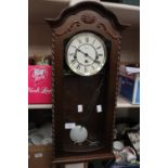 A drop-dial wall clock Hermle, with pendulum and key, Roman numerals,