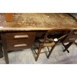 A mid 20th Century oak kneehole desk,