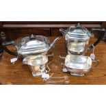 A four piece silver tea service comprising: teapot, hot water jug,