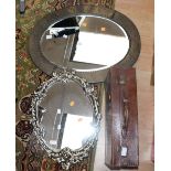 An oval Art Deco hammered brass mirror, bevelled glass with gesso mirror and a suitcase.