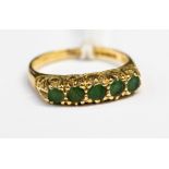 A five stone emerald 18ct yellow gold ring, ring size N, total gross weight approximately 3.