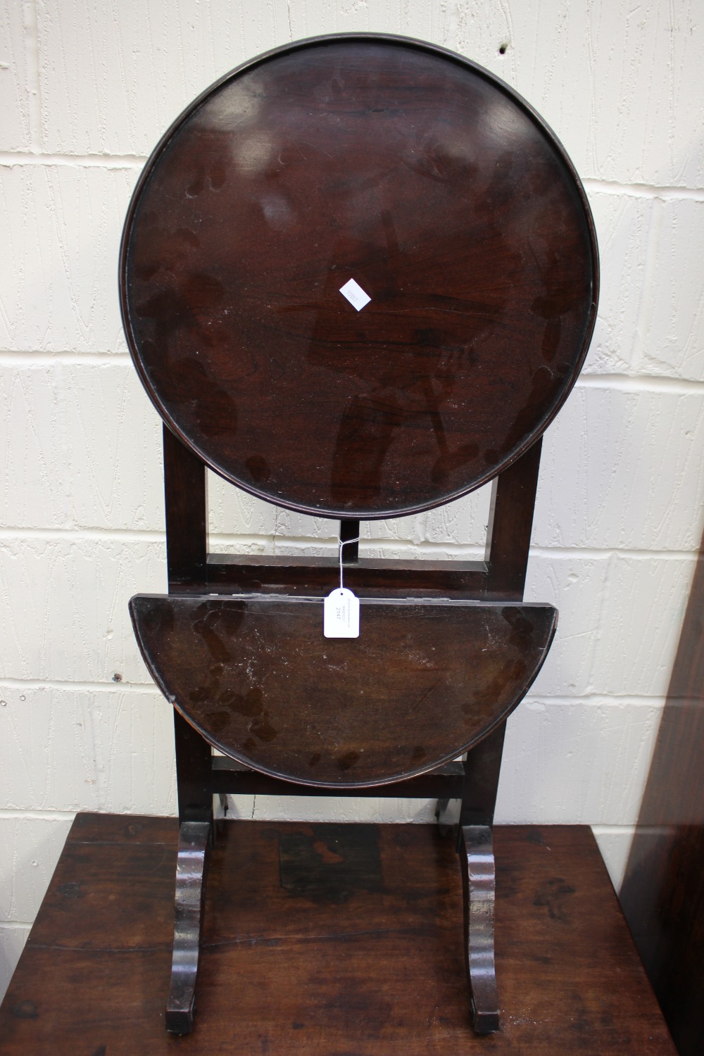 An early 20th Century mahogany two-tier folding what-not