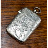 An early Edward VII silver vesta case with foliate decoration and engraved initials,