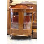 An Edwardian mahogany display cabinet, the two glazed doors opening to reveal a fitted interior,