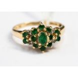 An emerald and diamond 14 ct yellow gold cluster ring, ring size P½,