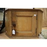 A late Victorian pine corner cupboard, circa 1900, fitted with a single door, 37cm high,